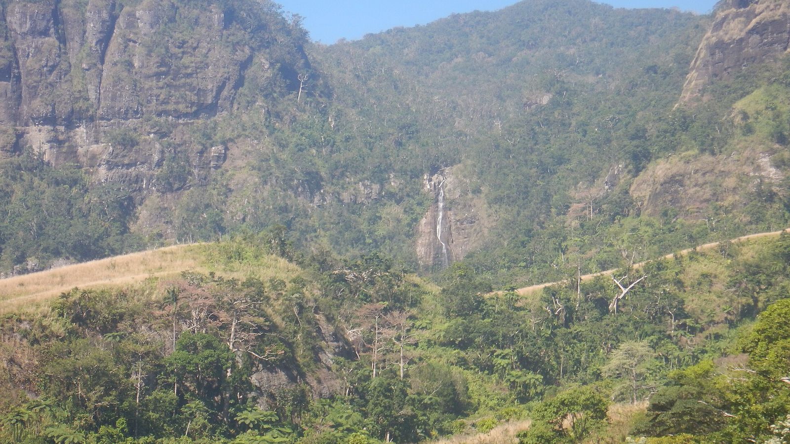 Smalle waterval in een groene, beboste vallei van het Koroyanitu National Heritage Park op Viti Levu